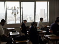 Buildings of Hiroshima downtown are viewed through classroom windows as students attend a lecture at Hiroshima Korean School on May 9, 2021...