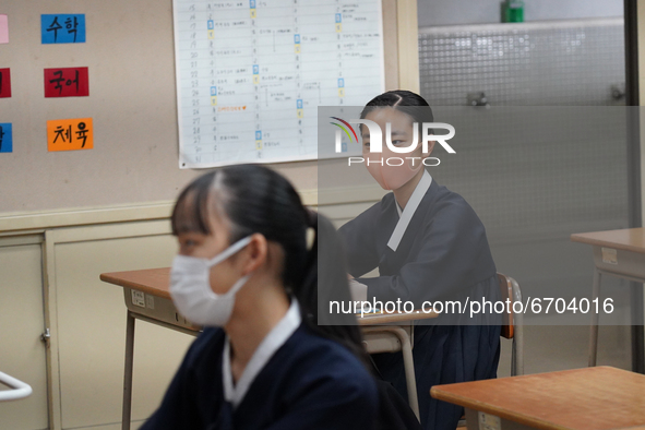 Students wearing face masks stay seated at their desks during a lecture at Hiroshima Korean School on May 9, 2021 in Hiroshima, Japan. The s...