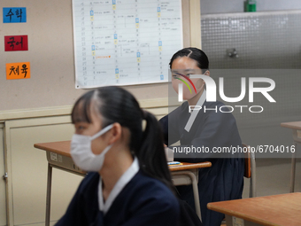 Students wearing face masks stay seated at their desks during a lecture at Hiroshima Korean School on May 9, 2021 in Hiroshima, Japan. The s...