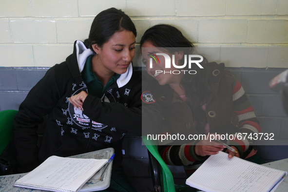 Two teenage women from a primary school in Mexico take classes during the back-to-school period to continue their studies in Mexico City, Me...