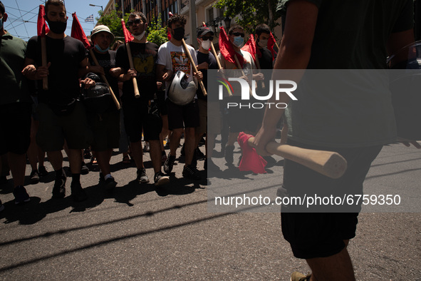  A student is holding a red flag during a protest  in Athens, Greece, on May 27, 2021. 