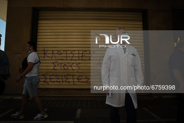 A man is watching the protesters in Athens, Greece, on May 27, 2021. 