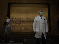 A man is watching the protesters in Athens, Greece, on May 27, 2021. (