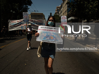 A student is holding a banner in Athens, Greece, on May 27, 2021. (