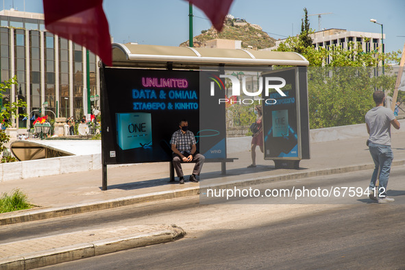 A man is watching the protesters in Athens, Greece, on May 27, 2021. 