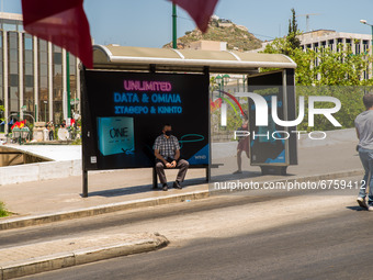 A man is watching the protesters in Athens, Greece, on May 27, 2021. (