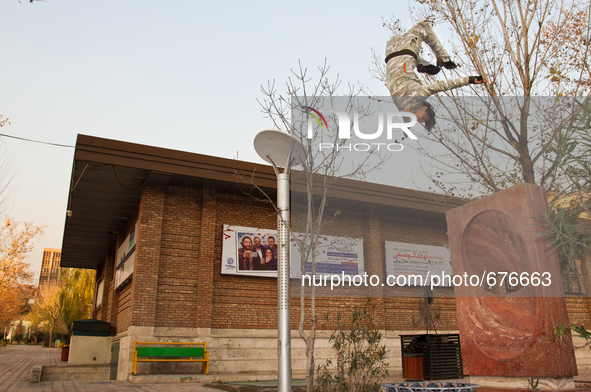 Parkour performer jumps in the area of the university of art in Tehran. 