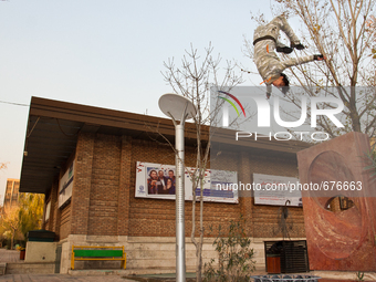 Parkour performer jumps in the area of the university of art in Tehran. (