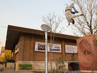 Parkour performer jumps in the area of the university of art in Tehran. (