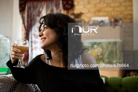 Young woman drinks the home made beer. 