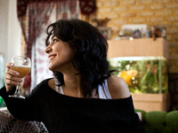 Young woman drinks the home made beer. (