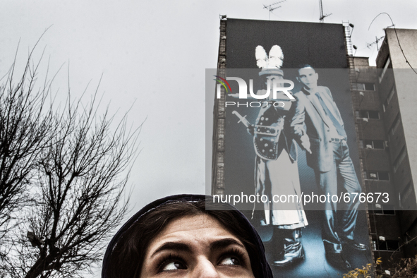 Symbolic portrait of young woman that looks at the old govermental painting of the well known enemies. 