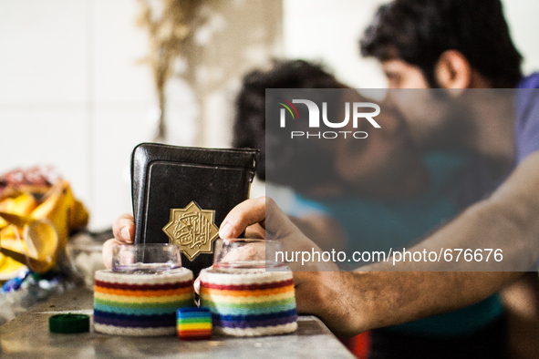 Gay couple kissing and holding the Koran as a symbol of the struggle for change.

 