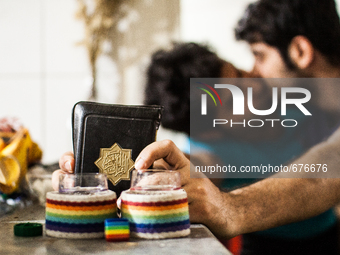 Gay couple kissing and holding the Koran as a symbol of the struggle for change.

 (