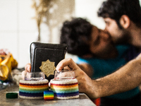 Gay couple kissing and holding the Koran as a symbol of the struggle for change.

 (