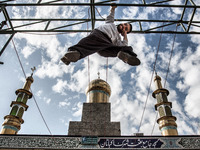 Parkour performer and the mosque in the background. (