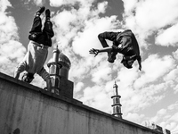 Parkour performers in Ekbatan and the mosque in the background.

 (