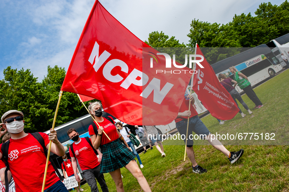 A group of students holding big flags are arriving by bus to the Malieveld in The Hague, Netherlands where a Nationwide student strike was o...