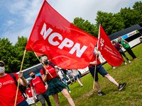 A group of students holding big flags are arriving by bus to the Malieveld in The Hague, Netherlands where a Nationwide student strike was o...