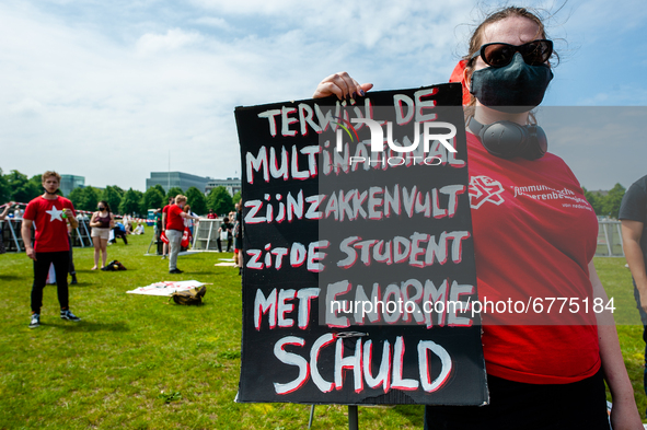 A student is holding a big placard against the student loan system, during the Nationwide student strike, organized in The Hague, Netherland...