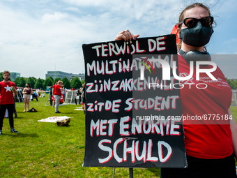 A student is holding a big placard against the student loan system, during the Nationwide student strike, organized in The Hague, Netherland...