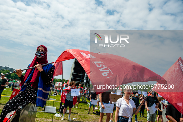 A student wearing a hijab is holding a flag, during the Nationwide student strike, organized in The Hague, Netherlands on June 3rd, 2021. 