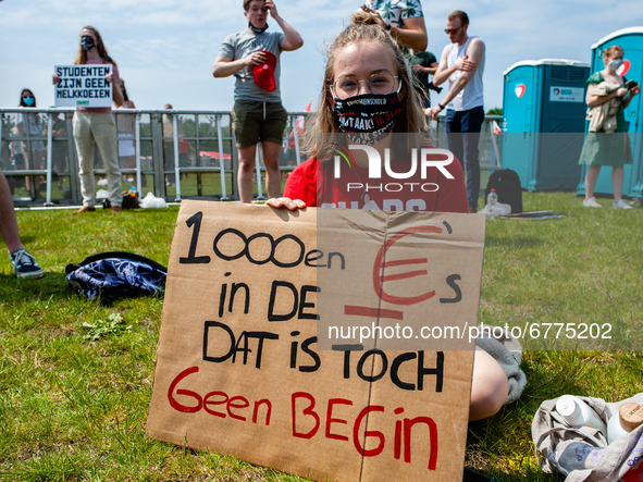 A student is sitting while holding a placard against the student loan system, during the Nationwide student strike, organized in The Hague,...