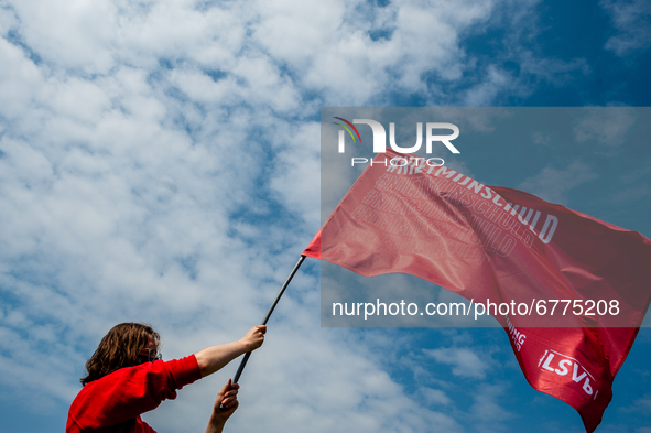 A student is holding a big red flag that says it's not my fault, the slogan of the student protest, during the Nationwide student strike, or...