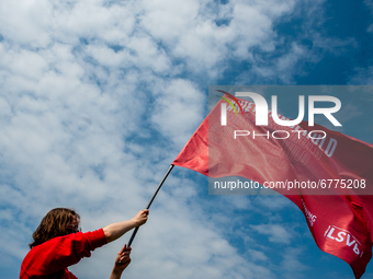 A student is holding a big red flag that says it's not my fault, the slogan of the student protest, during the Nationwide student strike, or...