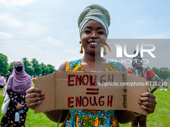 A Black student is holding a placard that says in Dutch enough is enough, during the Nationwide student strike, organized in The Hague, Neth...