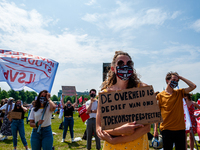 A woman is holding a placard against the student loan system, during the Nationwide student strike, organized in The Hague, Netherlands on J...