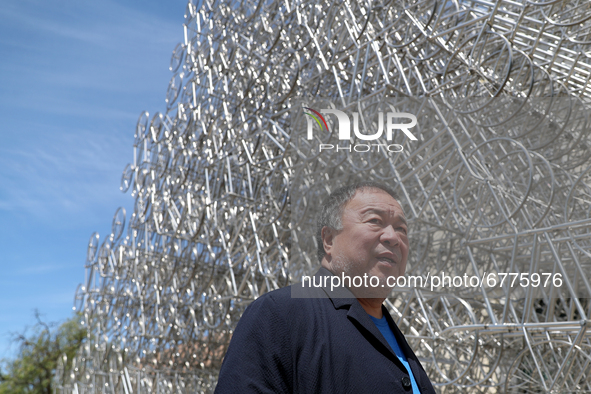 Chinese artist Ai Weiwei poses in front of his sculpture "Forever Bicycles"  during a press preview of his new exhibition 'Rapture'  at the...