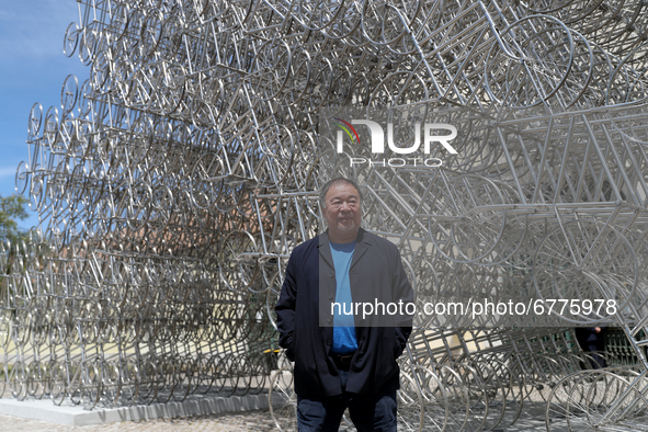 Chinese artist Ai Weiwei poses in front of his sculpture "Forever Bicycles"  during a press preview of his new exhibition 'Rapture'  at the...