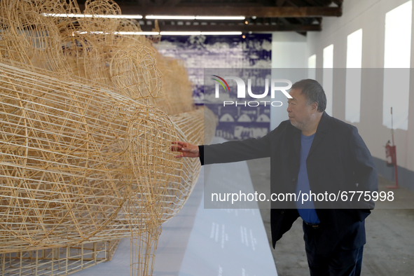 Chinese artist Ai Weiwei touches one of his artworks during a press preview of his new exhibition 'Rapture'  at the Cordoaria Nacional in Li...