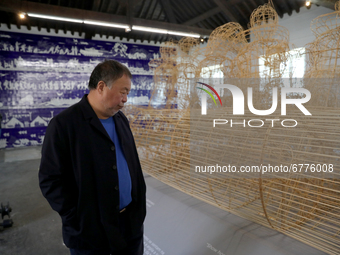 Chinese artist Ai Weiwei looks at one of his artworks during a press preview of his new exhibition 'Rapture'  at the Cordoaria Nacional in L...