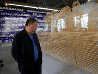 Chinese artist Ai Weiwei looks at one of his artworks during a press preview of his new exhibition 'Rapture'  at the Cordoaria Nacional in L...