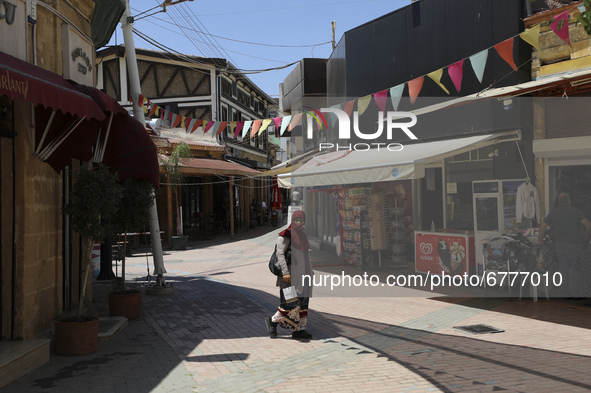 A Turkish Cypriot woman walks down a street in Turkish-occupied territory in the northern part of the divided capital Nicosia. Cyprus, Frida...