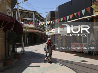 A Turkish Cypriot woman walks down a street in Turkish-occupied territory in the northern part of the divided capital Nicosia. Cyprus, Frida...