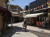 A Turkish Cypriot woman walks down a street in Turkish-occupied territory in the northern part of the divided capital Nicosia. Cyprus, Frida...