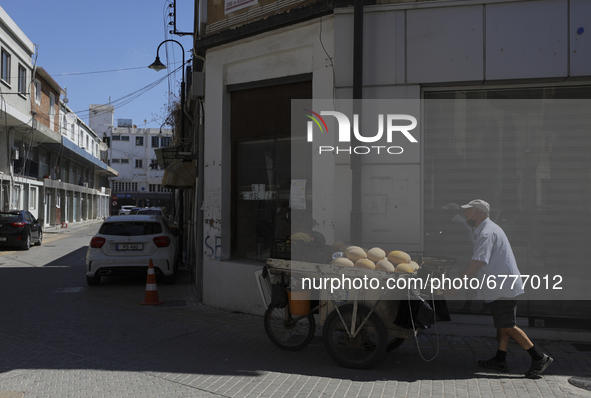 A Turkish Cypriot man pulls a cart of melons for sale down a street in Turkish-occupied territory in the northern part of the divided capita...