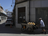 A Turkish Cypriot man pulls a cart of melons for sale down a street in Turkish-occupied territory in the northern part of the divided capita...