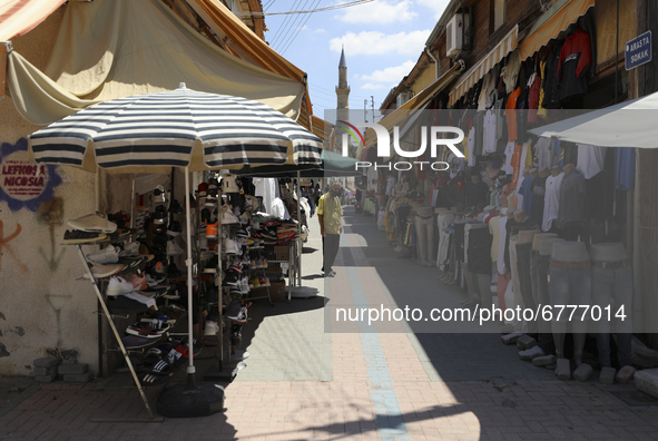 A Turkish Cypriot man sells clothes on a shopping street in Turkish-occupied territory in the northern part of the divided capital Nicosia....