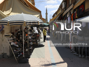 A Turkish Cypriot man sells clothes on a shopping street in Turkish-occupied territory in the northern part of the divided capital Nicosia....