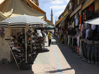 A Turkish Cypriot man sells clothes on a shopping street in Turkish-occupied territory in the northern part of the divided capital Nicosia....