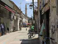 A Turkish Cypriot boy rides a bicycle along a shopping street in Turkish-occupied territory in the northern part of the divided capital Nico...