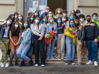 Last day of lessons of a difficult school year, smiles hidden among the masks and water balloons to celebrate the last day of school, with t...