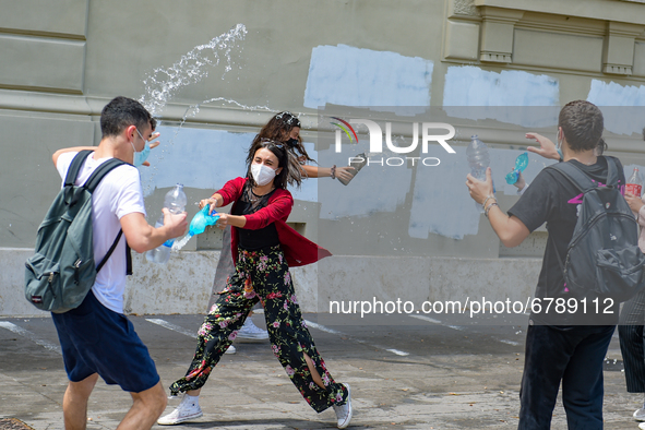 Last day of lessons of a difficult school year, smiles hidden among the masks and water balloons to celebrate the last day of school, with t...