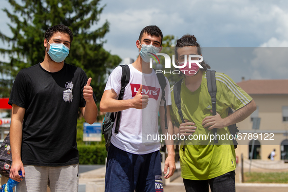 Last day of lessons of a difficult school year, smiles hidden among the masks and water balloons to celebrate the last day of school, with t...