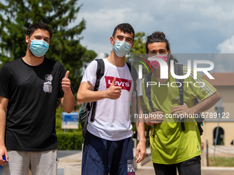 Last day of lessons of a difficult school year, smiles hidden among the masks and water balloons to celebrate the last day of school, with t...