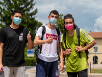 Last day of lessons of a difficult school year, smiles hidden among the masks and water balloons to celebrate the last day of school, with t...